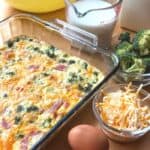 A glass baking dish filled with a broccoli quiche.