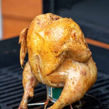 A whole chicken on a grill.