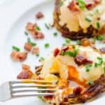 A fork piercing a poached egg.