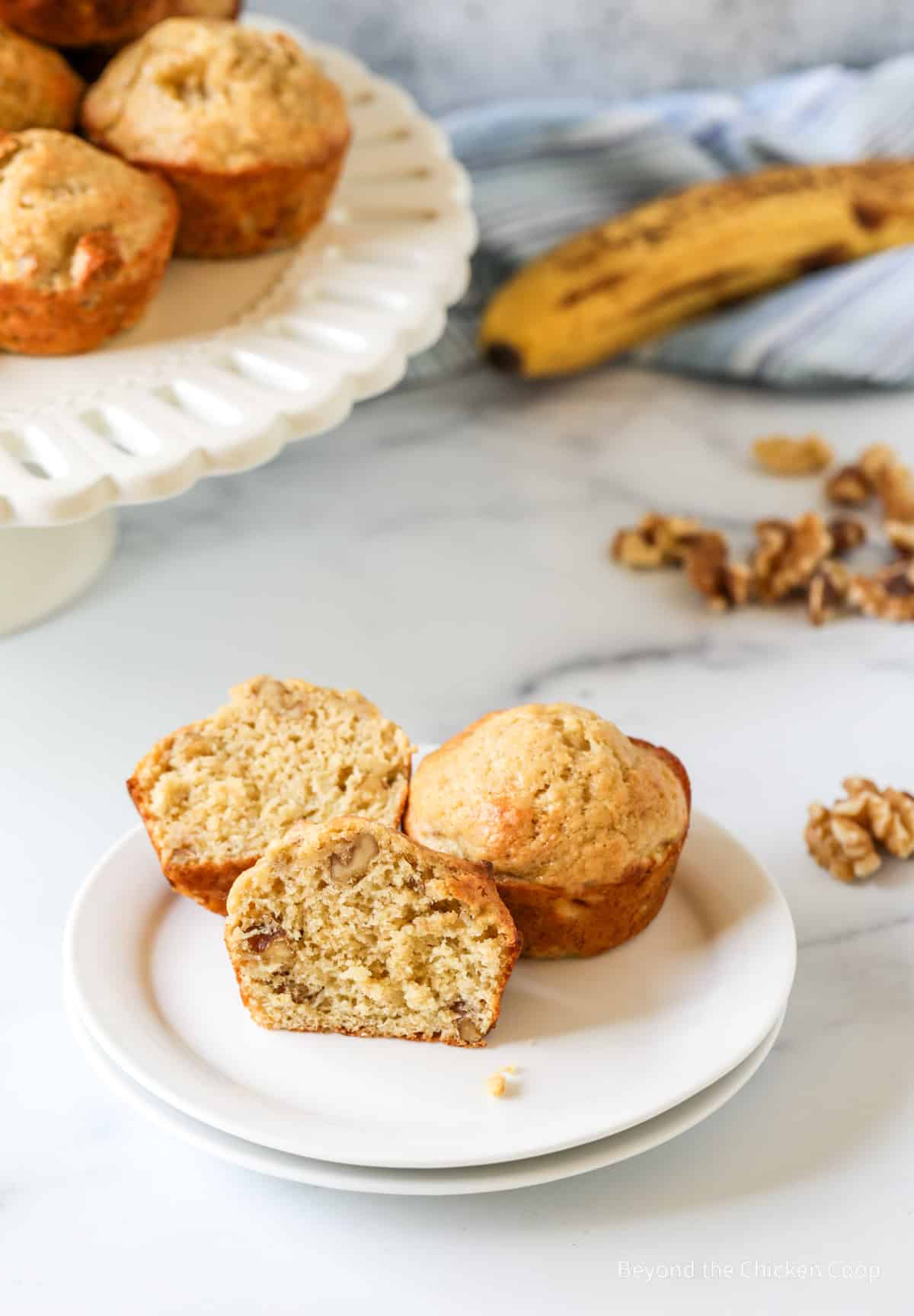 A muffin cut in half on a plate.