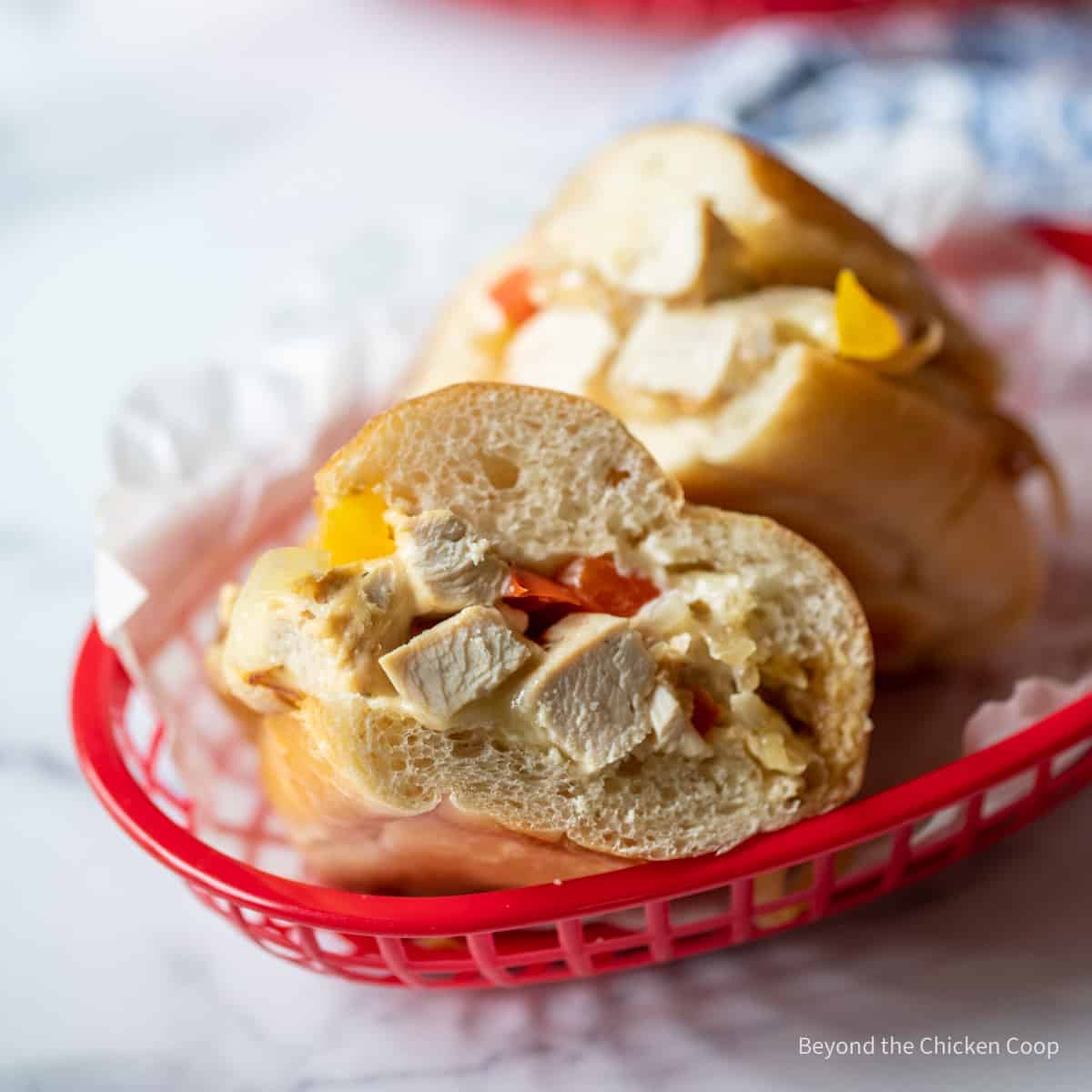 A chicken sandwich with peppers and onions.