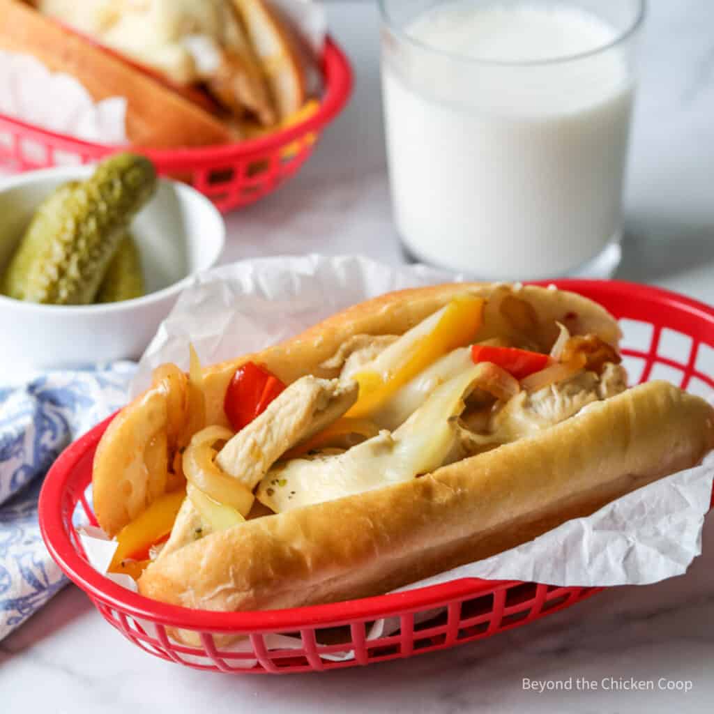 A hoagie roll with chicken, onions, peppers and cheese.