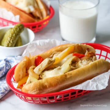 A hoagie roll with chicken, onions, peppers and cheese.