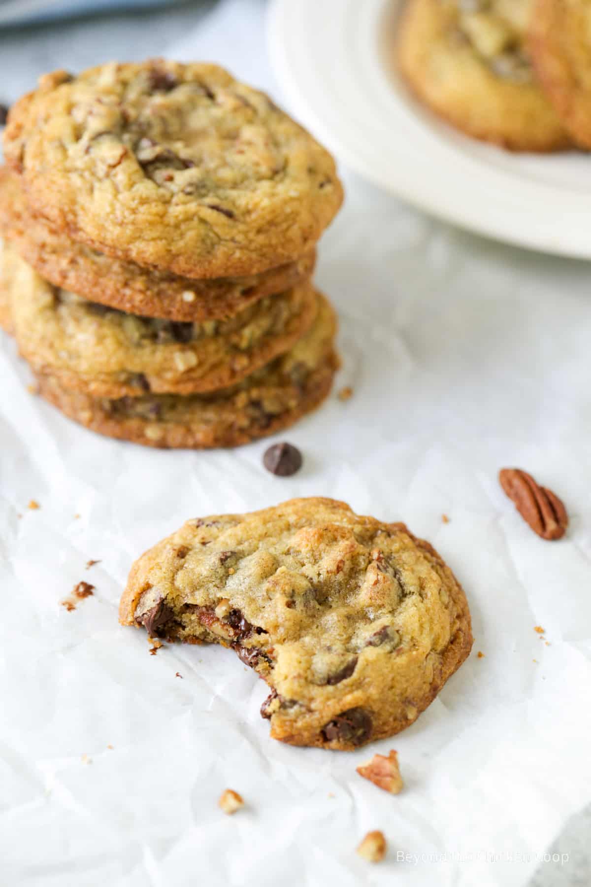 A chocolate chip cookie with a bite out of it.