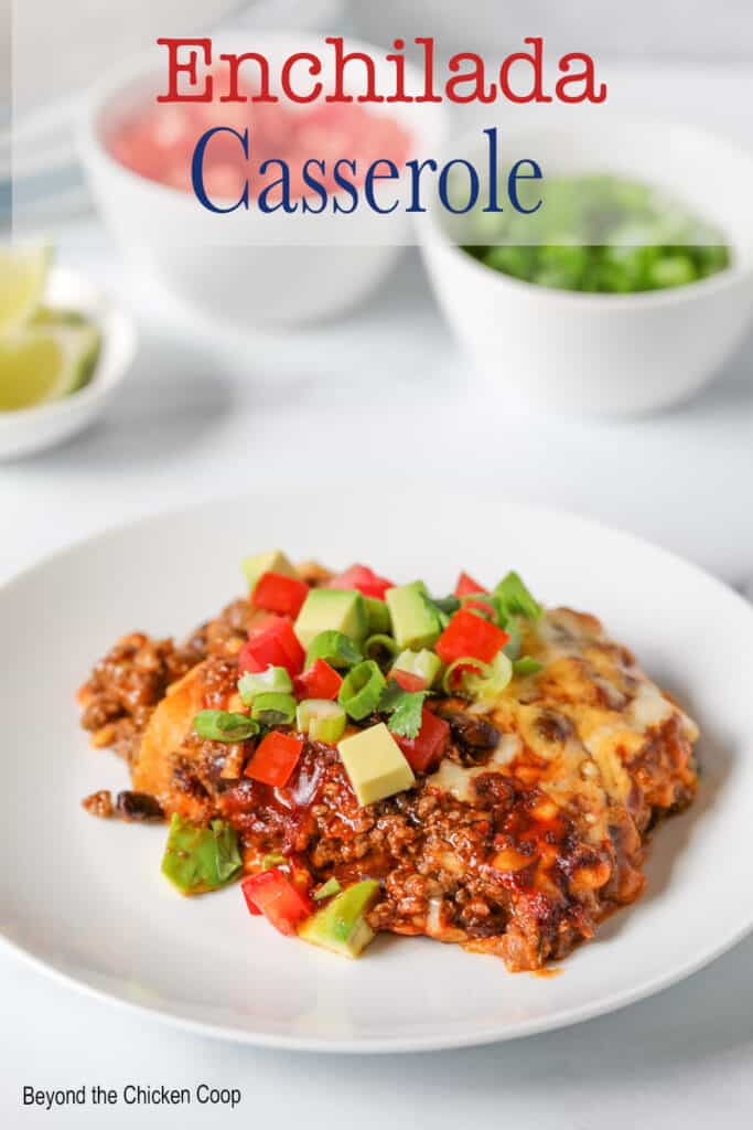 Beef casserole with tomatoes and avocados on top.