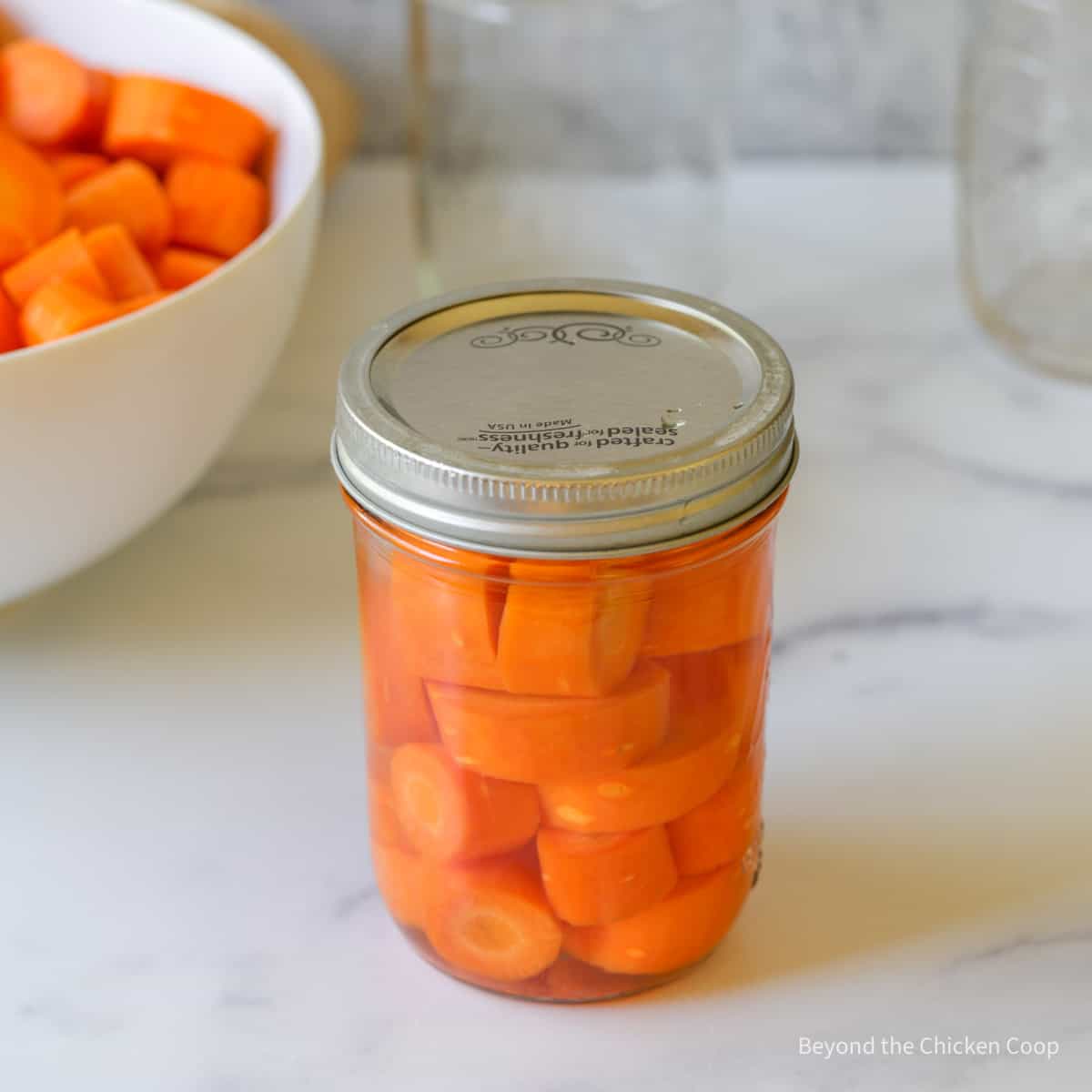 A canning jar filled with carrots.