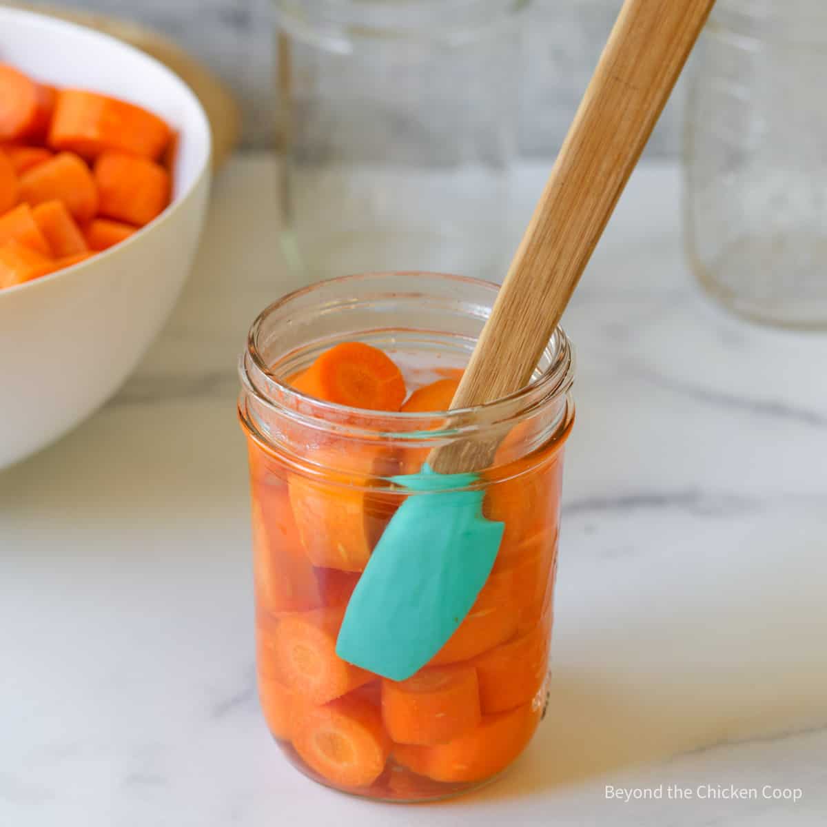 Removing air bubbles from a canning jar.