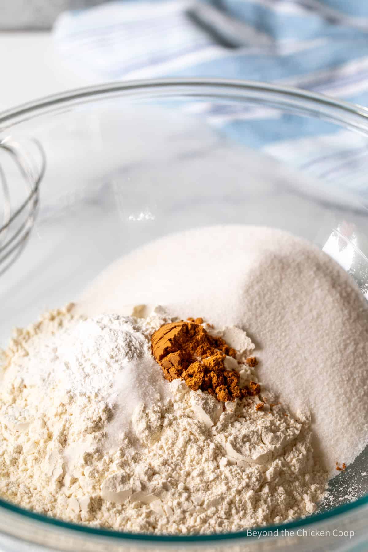Flour, sugar and ground cinnamon in a bowl.