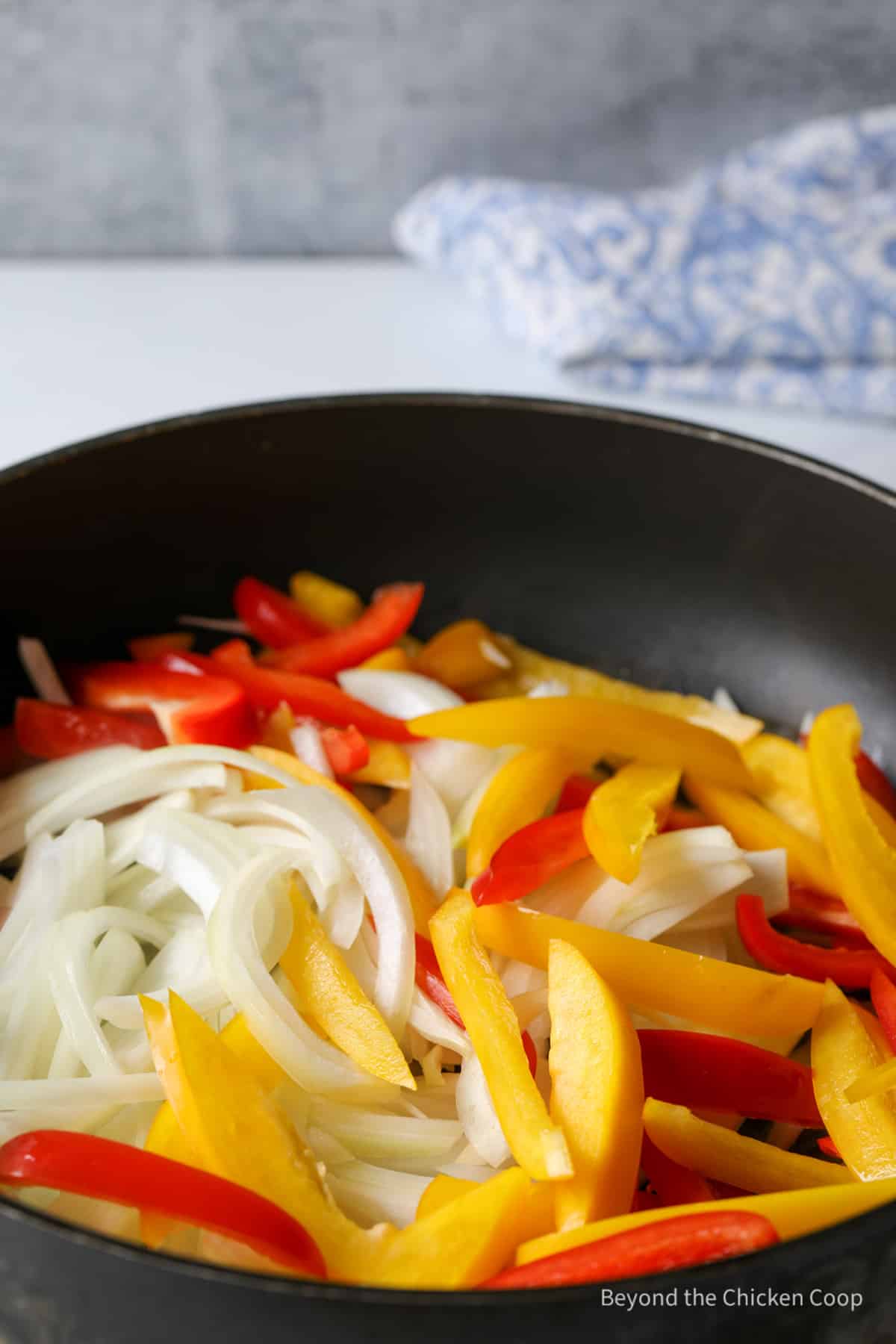 Peppers and onions in a pan.