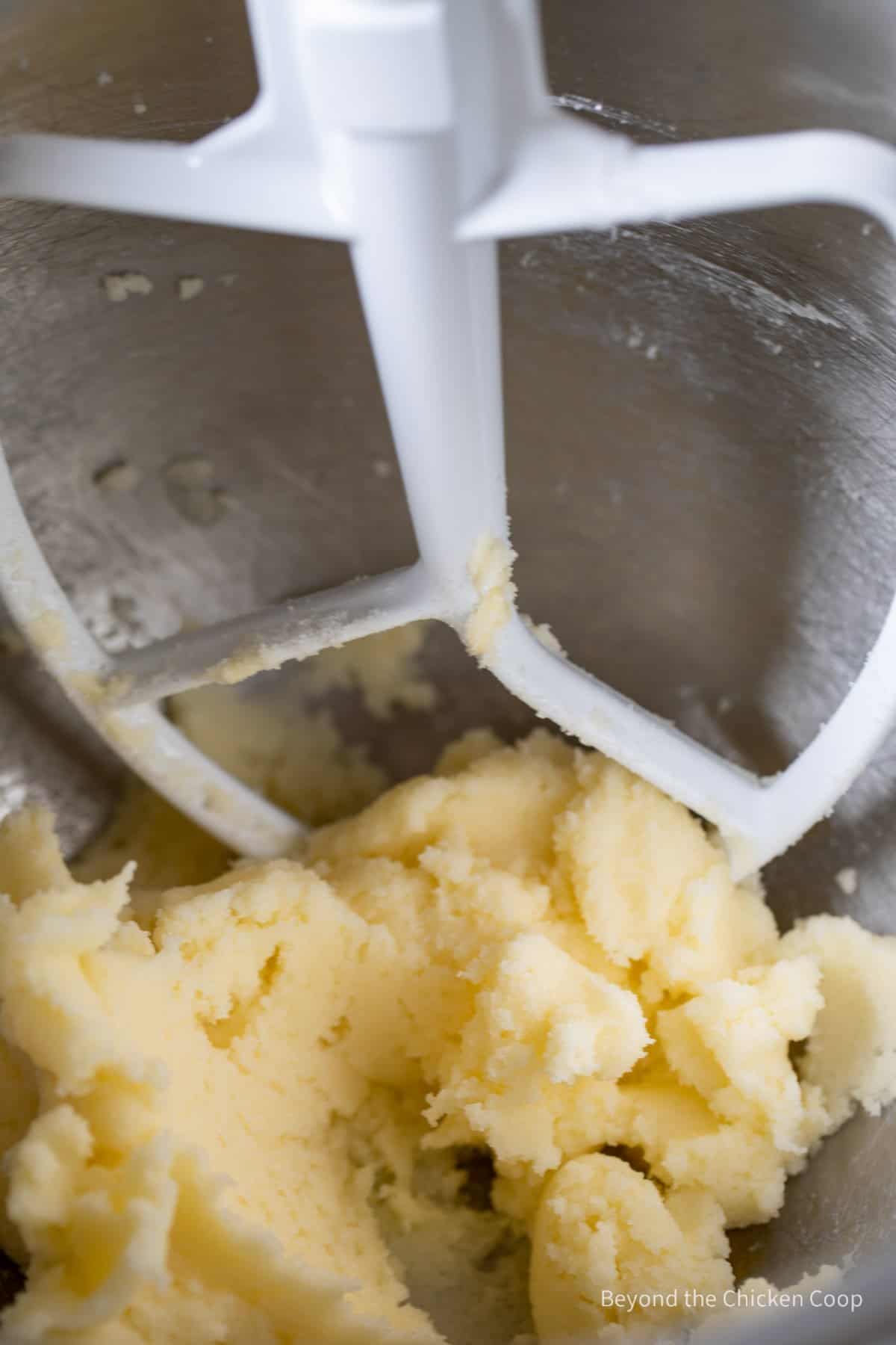 Butter and sugar mixed together in a bowl.