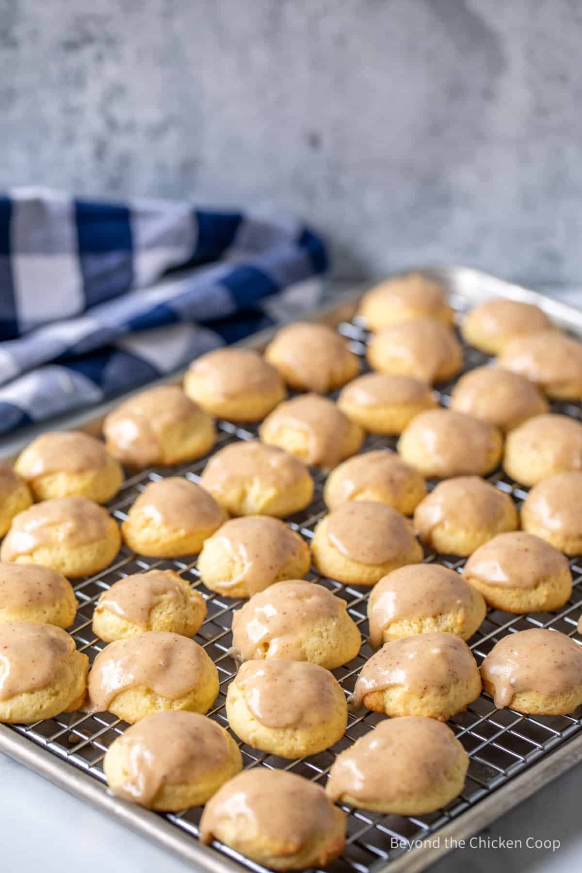 Cookies with a glaze on a baking rack.