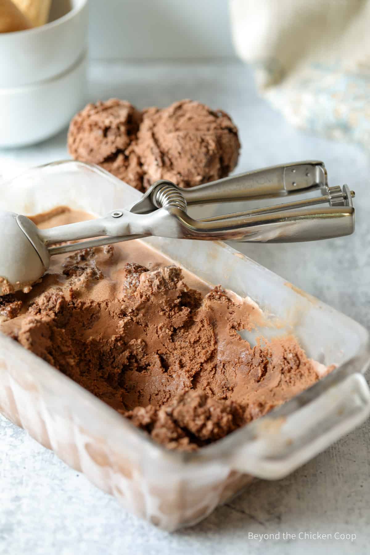 Chocolate ice cream in a glass dish.