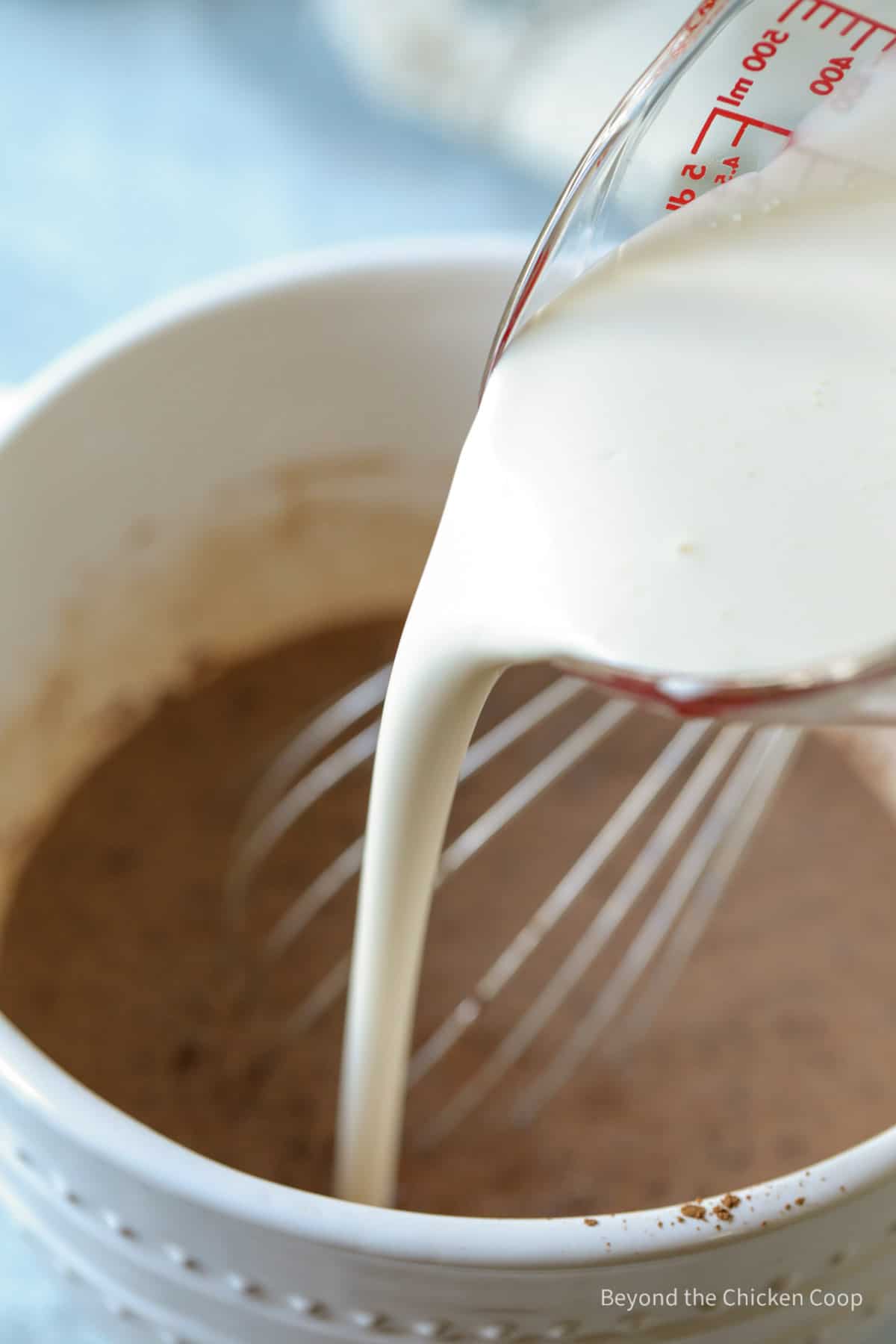 Adding cream to chocolate milk. 
