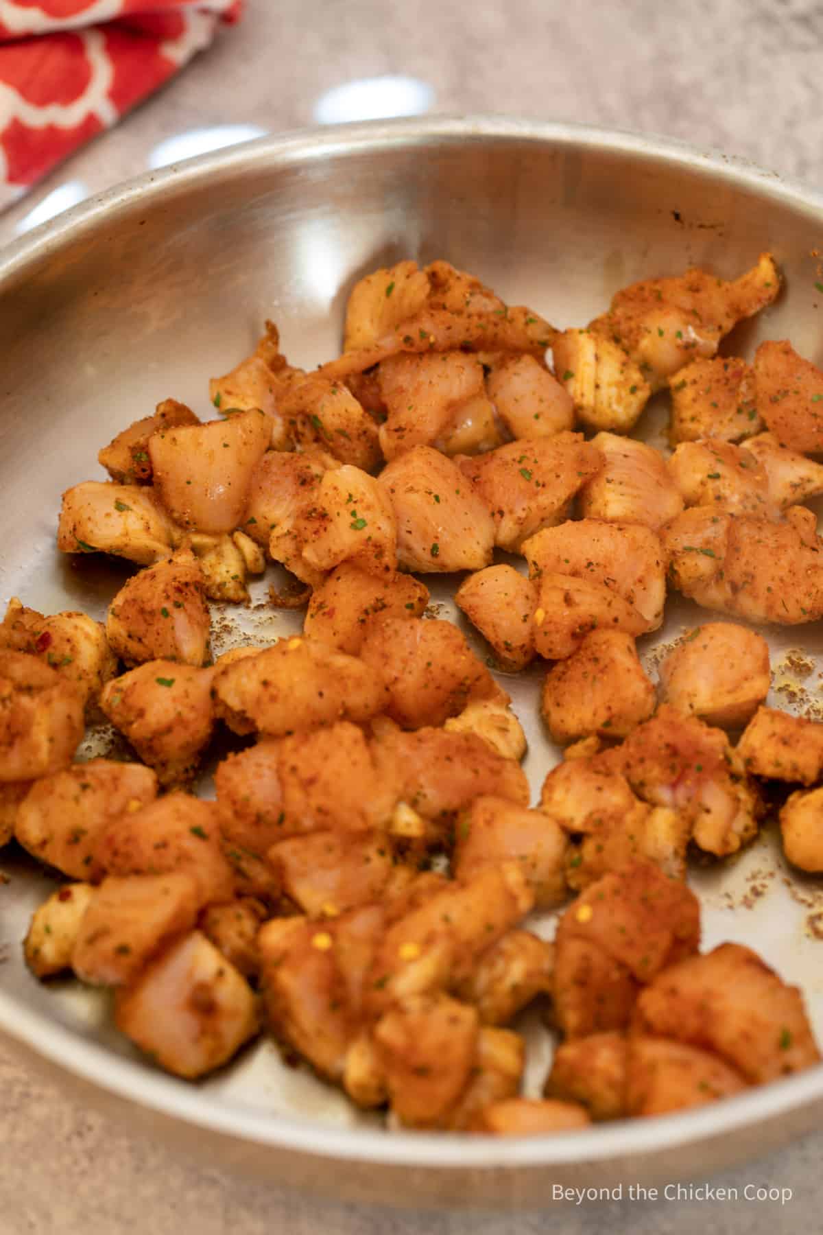 Cooking jerk chicken in a large pan.