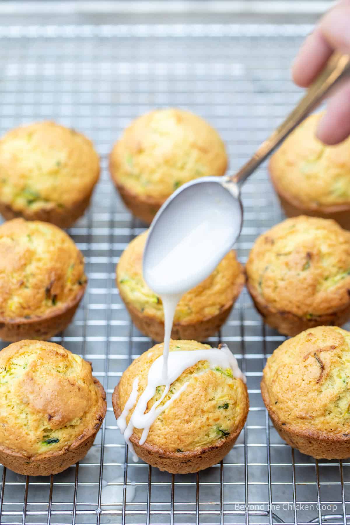 Drizzling a glaze over muffins.