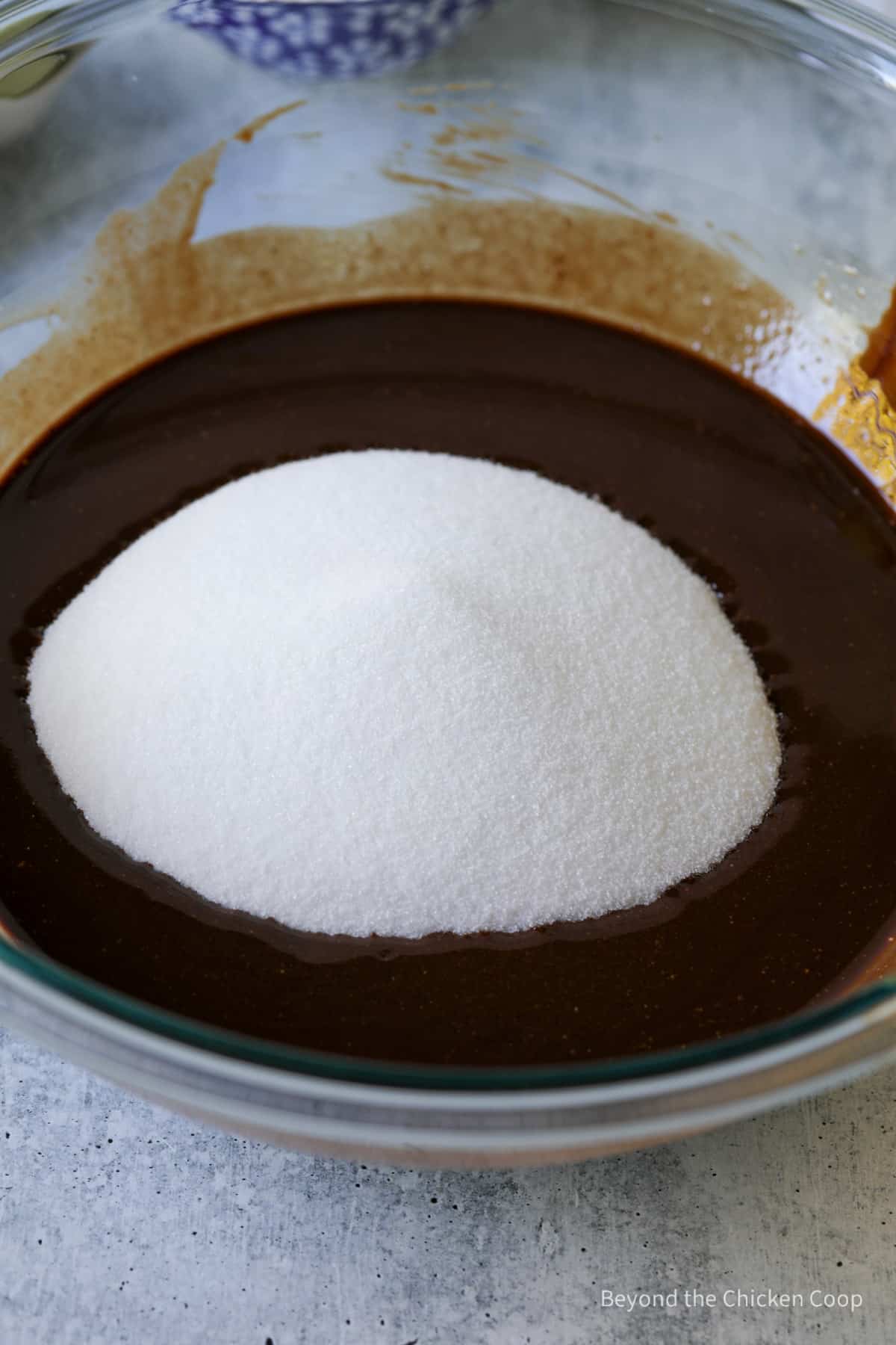Sugar added to melted chocolate.