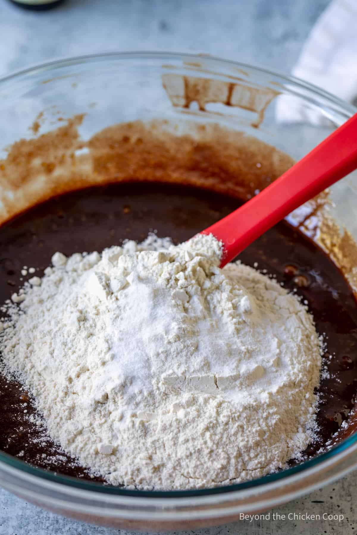 Flour being stirred into melted chocolate.