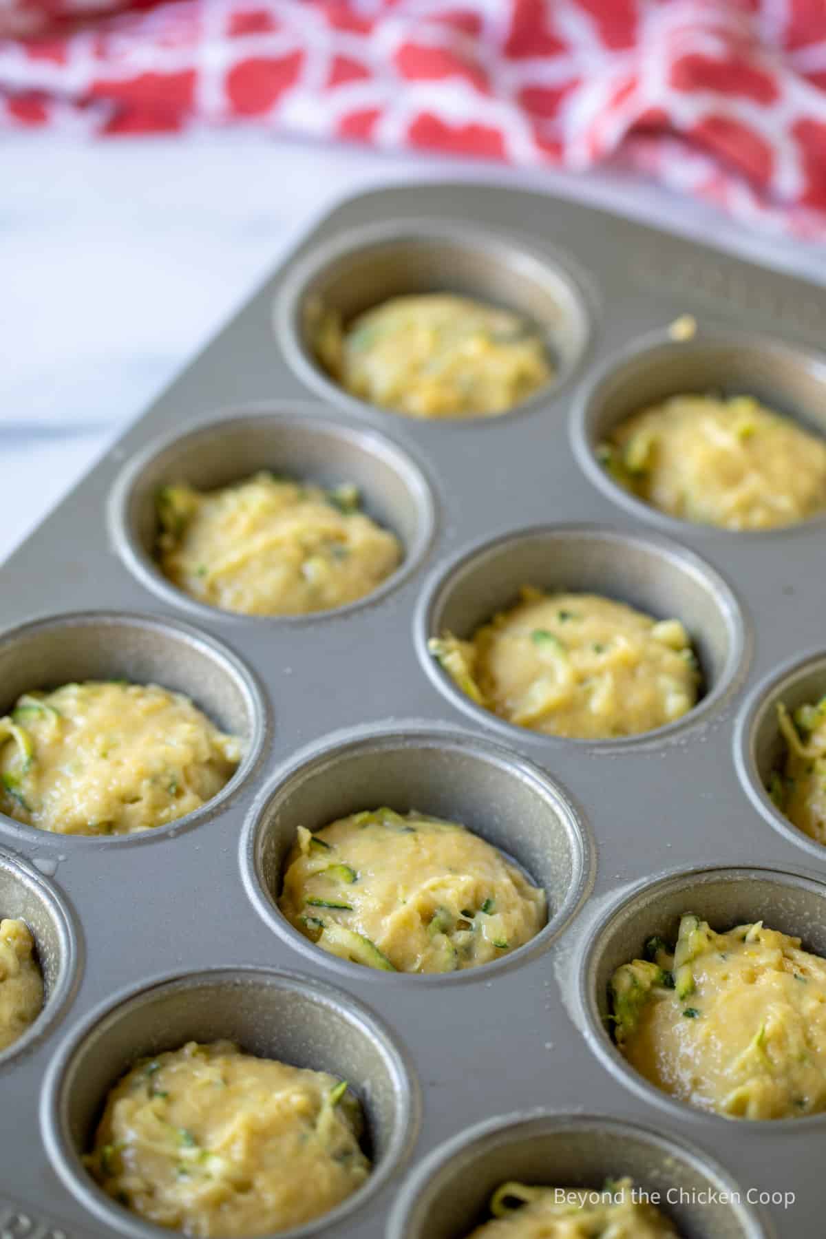 A muffin tin filled with batter.