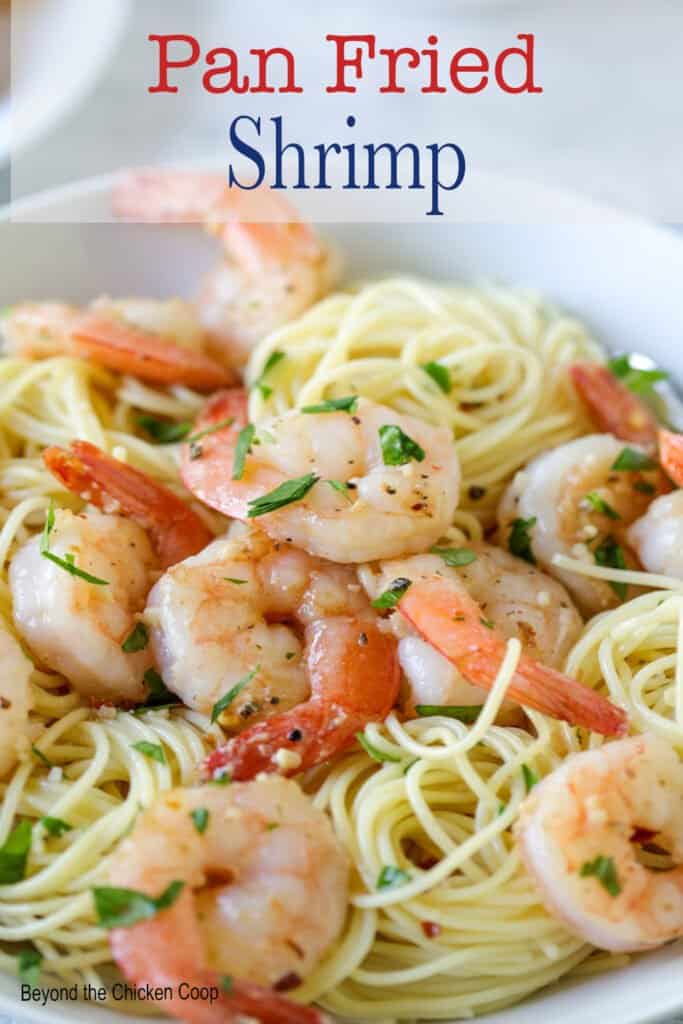 Pasta topped with cooked shrimp.