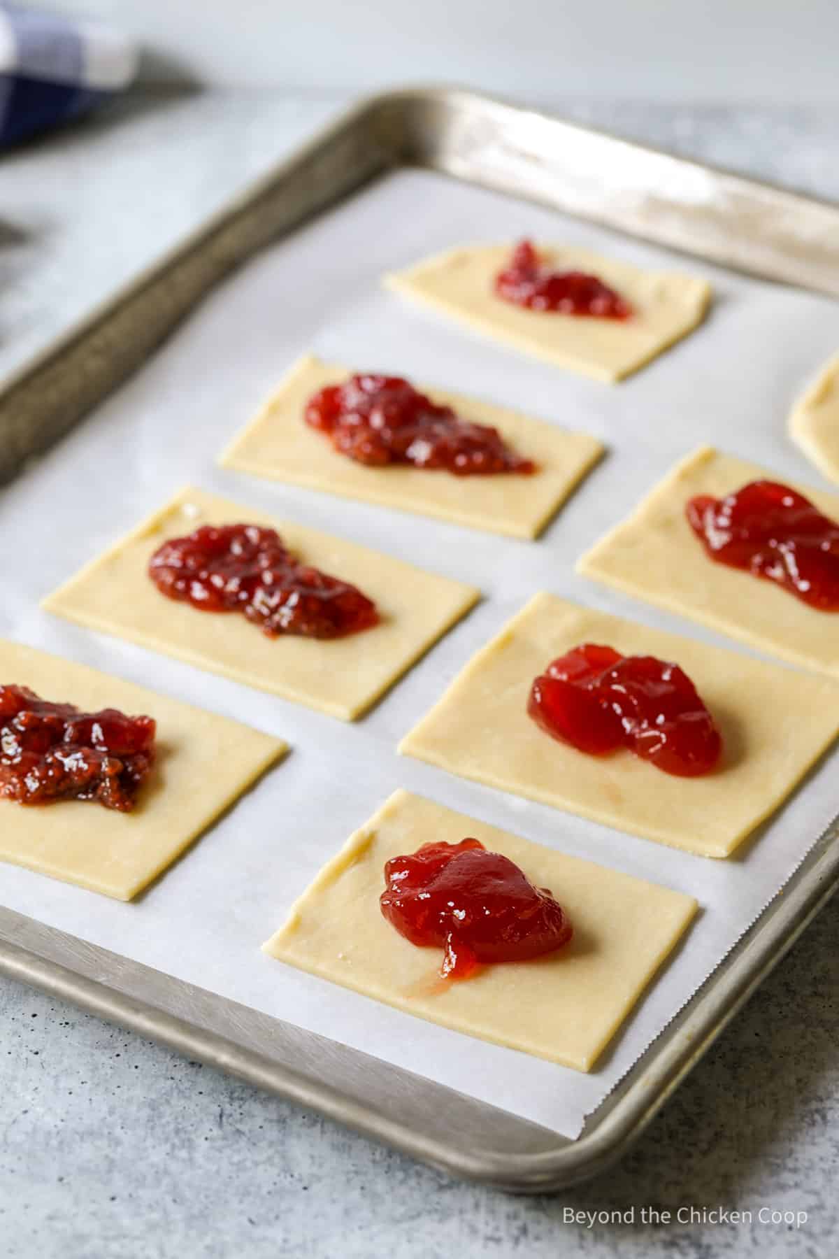 Pastry dough topped with a dollop of jam.