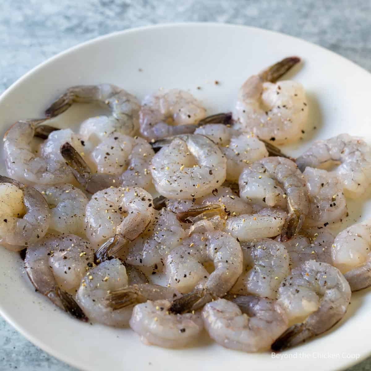 Salt and pepper on raw shrimp.