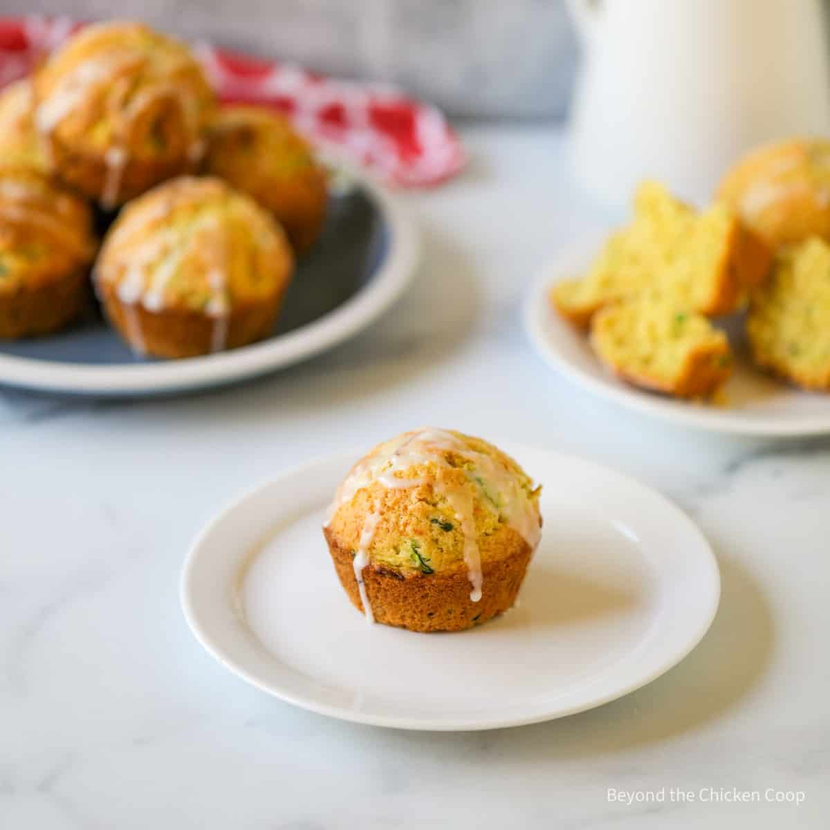 A muffin with a glaze drizzled over the top.