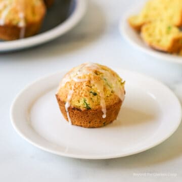 A zucchini muffin with a glaze on top.