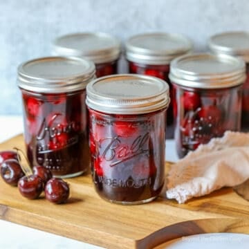 Canning jars filled with cherries.