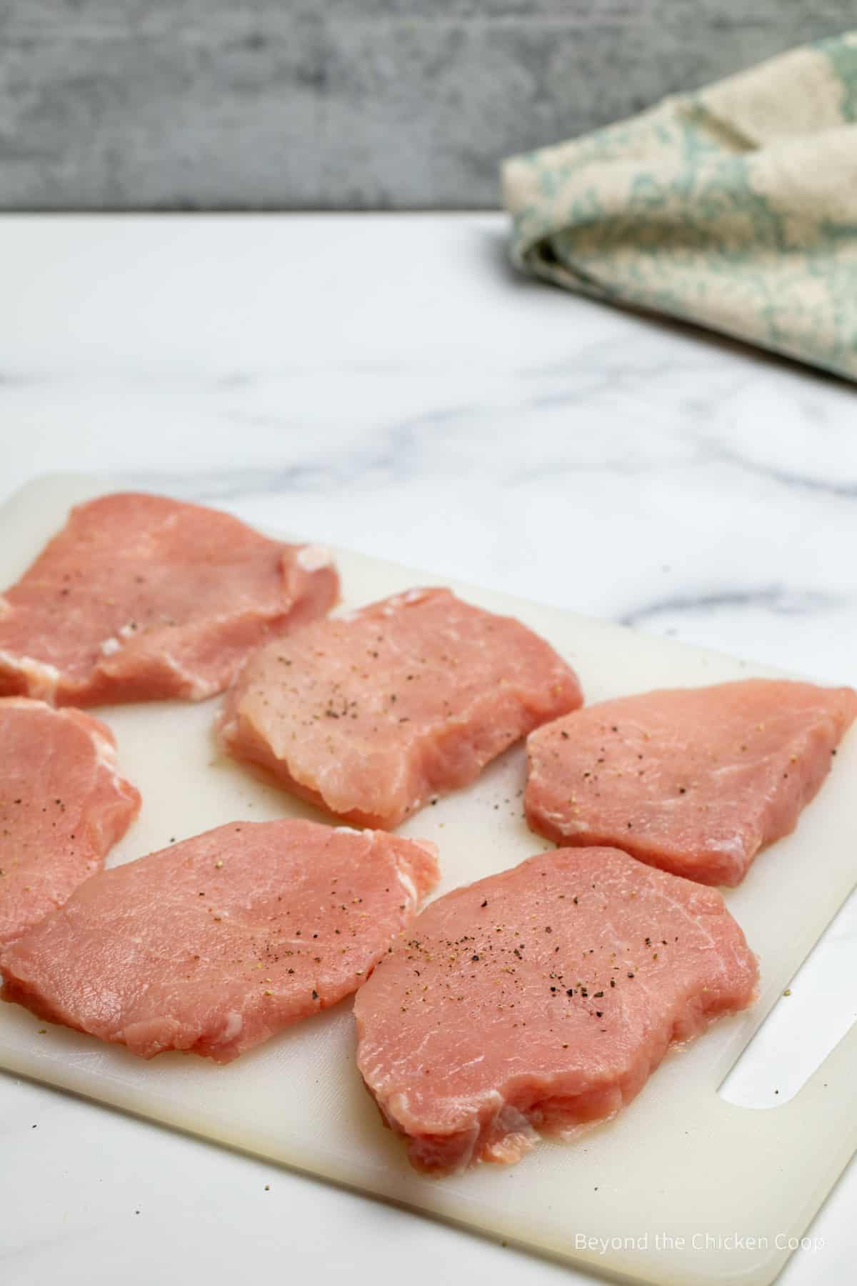 Thinly slice pork loin sprinkled with salt and pepper. 