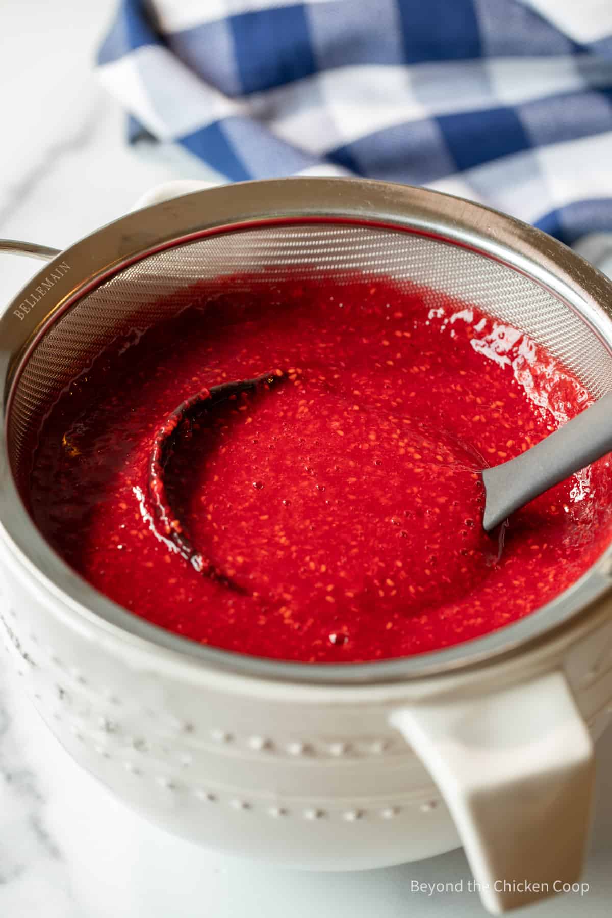 Raspberry puree in a sieve.