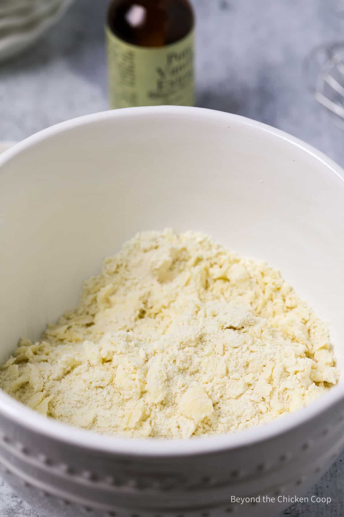 Crumbled flour and butter in a bowl.