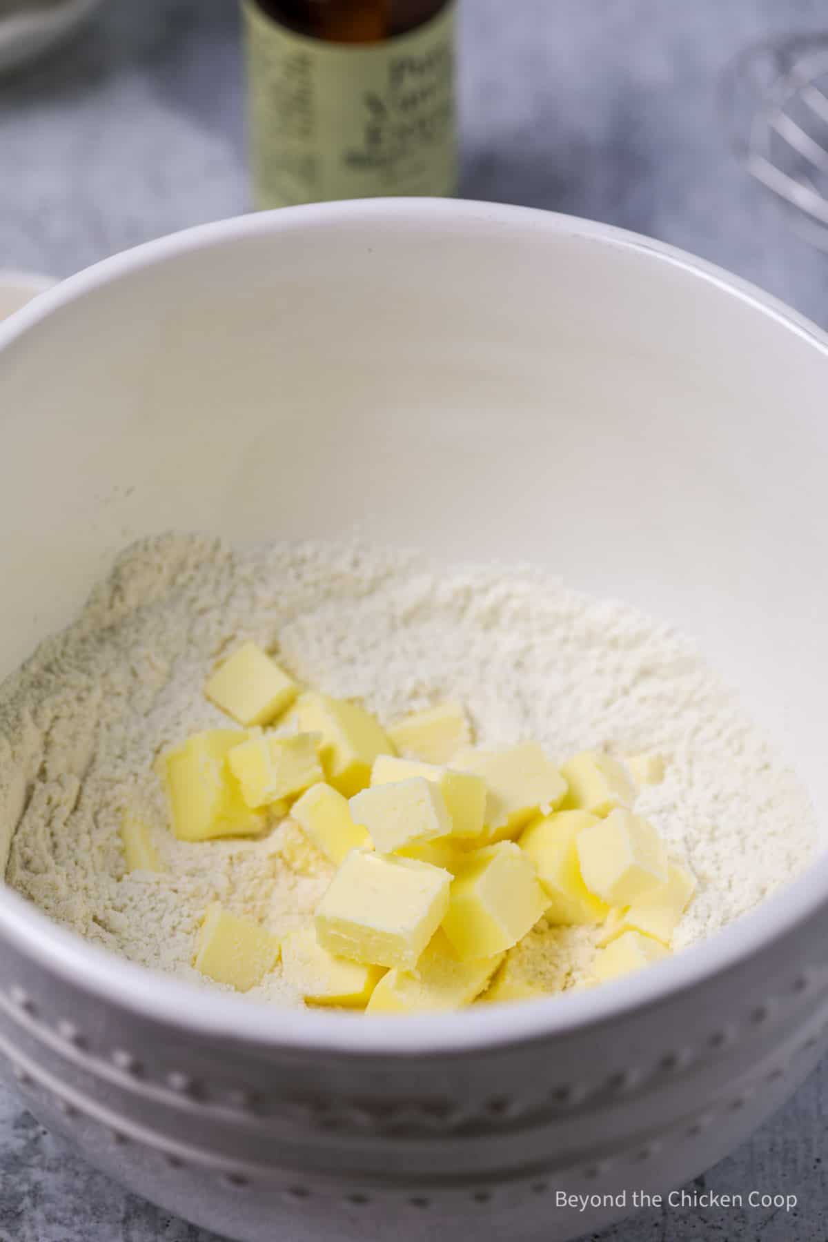 Cubed butter in a bowl with flour.