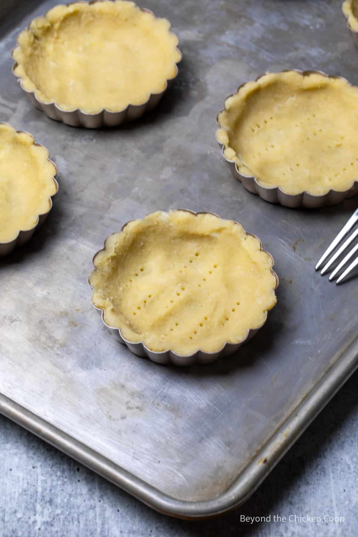 Tart dough with small pricks from a fork. 