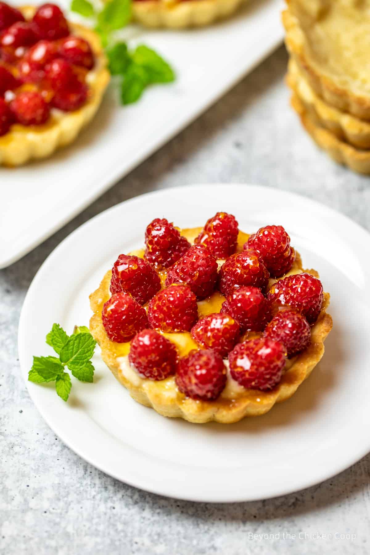 Small tart topped with fresh raspberries.