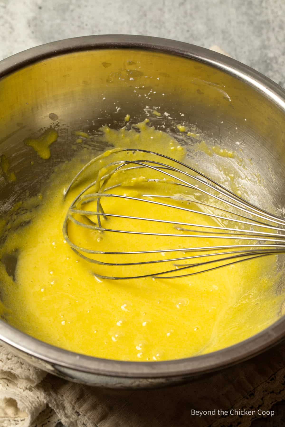 Whisked egg yolks in a bowl.