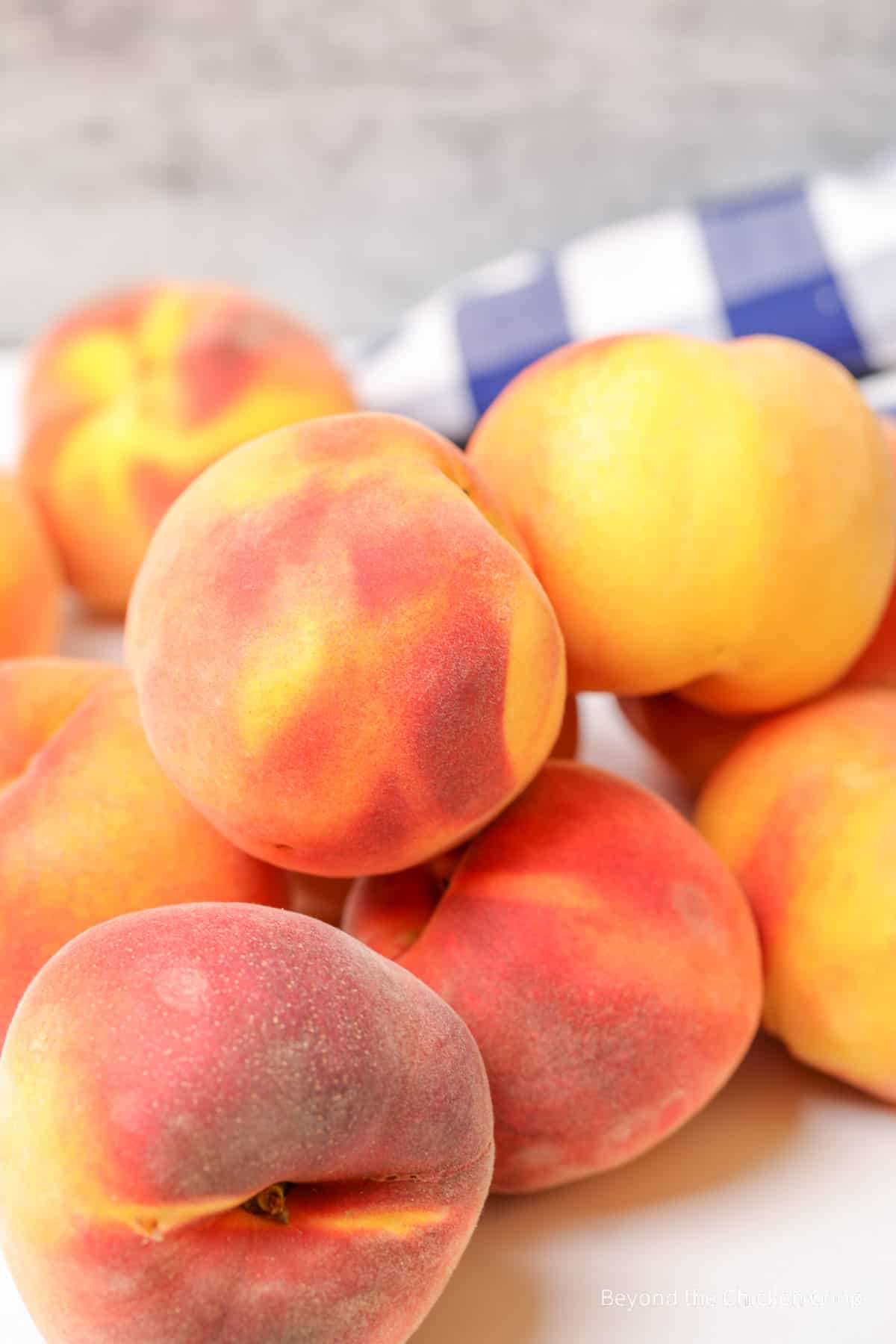 Fresh peaches piled together.
