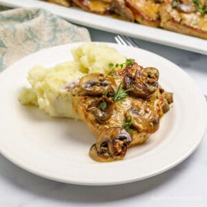 A pork medallion topped with a cream sauce and mushrooms.