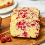 Slices or raspberry bread on a wooden cutting board.