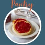 An english muffin topped with raspberry jam.