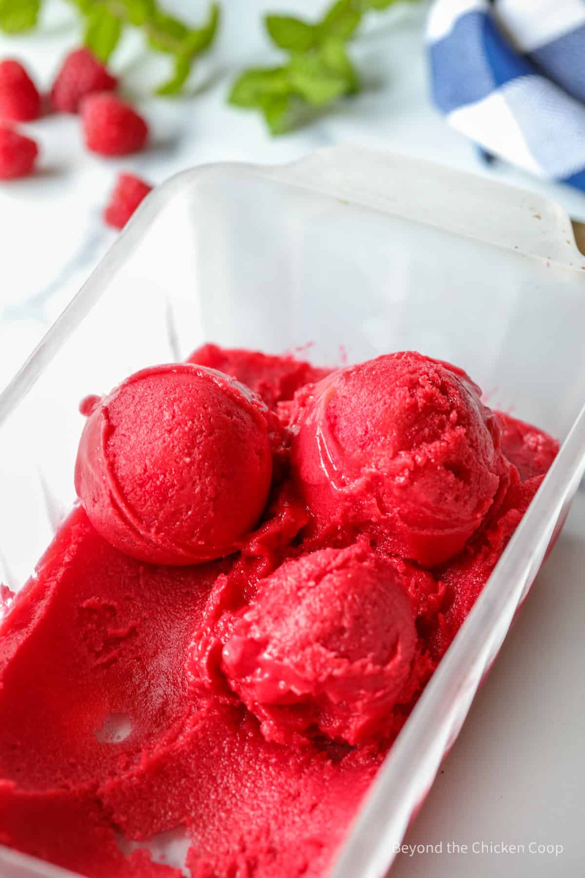 Scoops of sorbet in a glass container.