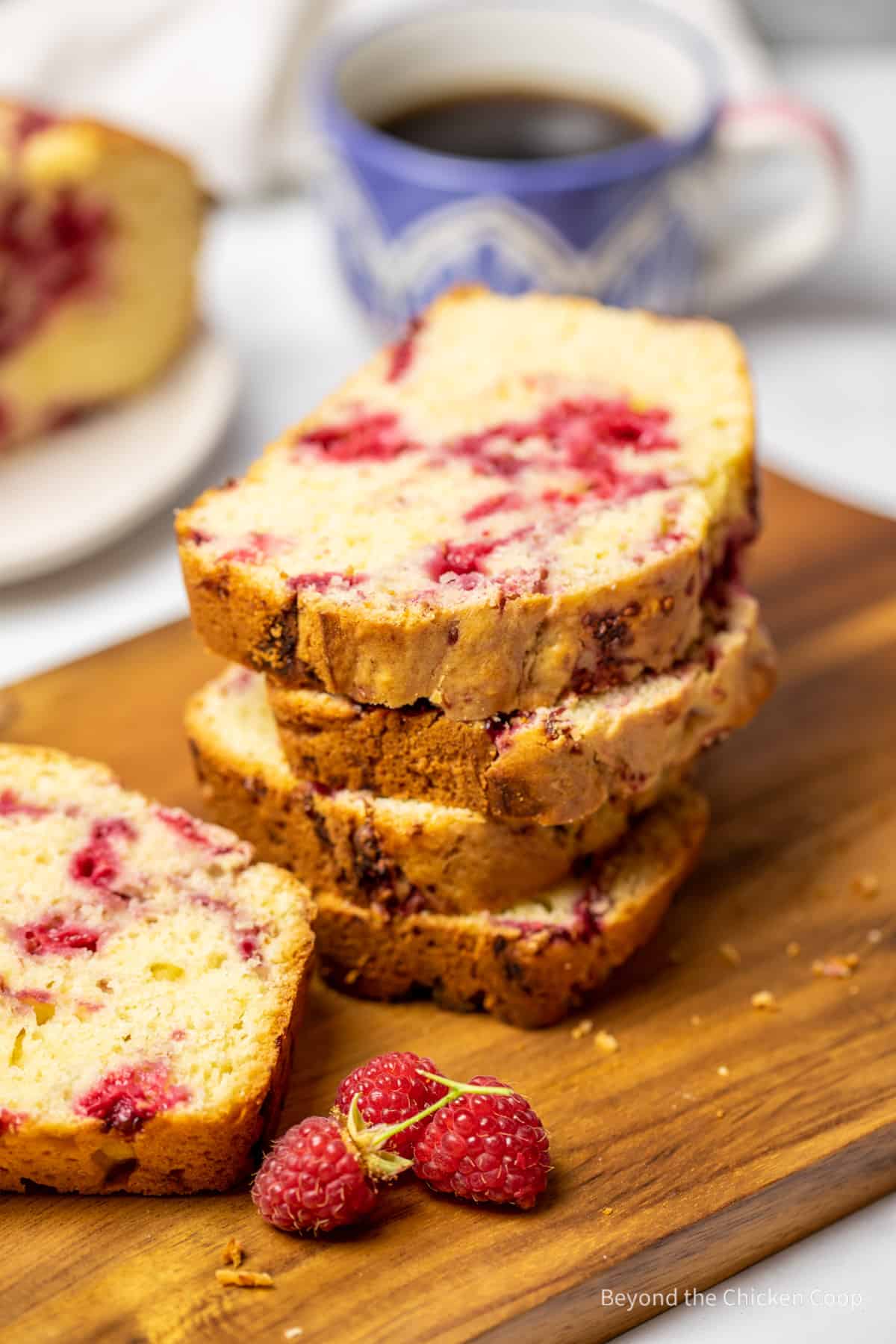 Sliced raspberry bread on a wooden board.