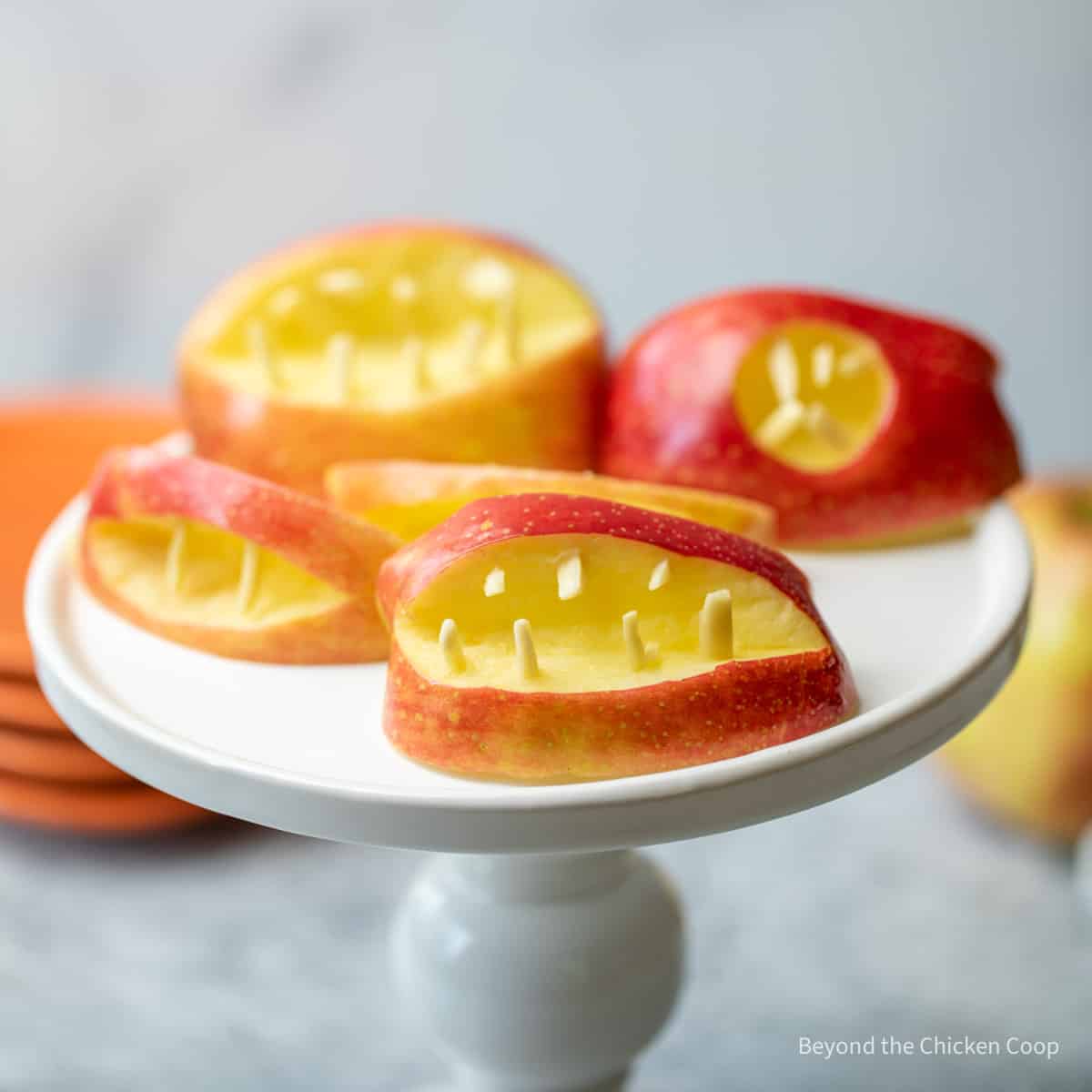 Apple teeth on a cake stand.