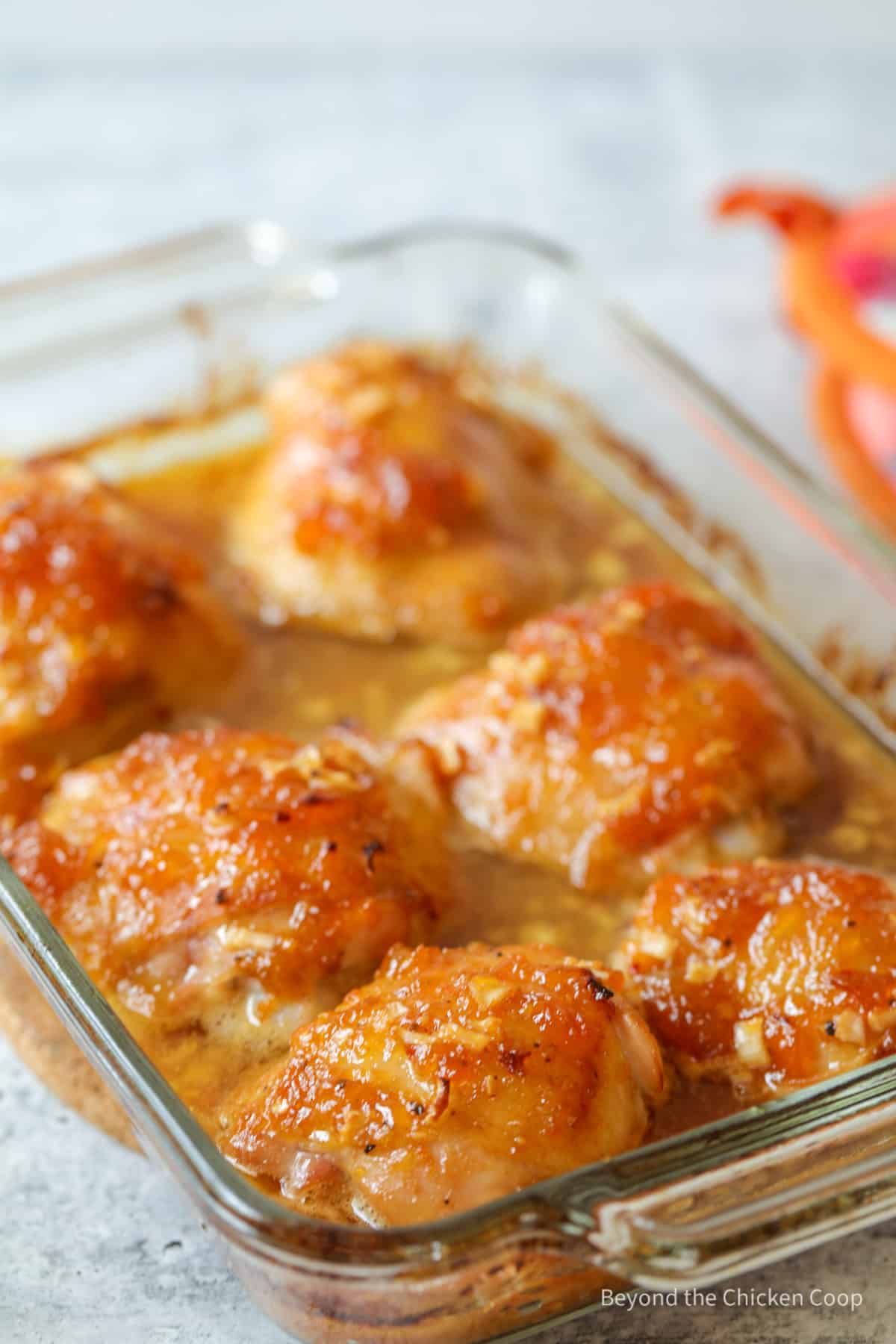 Apricot chicken in a glass casserole dish.