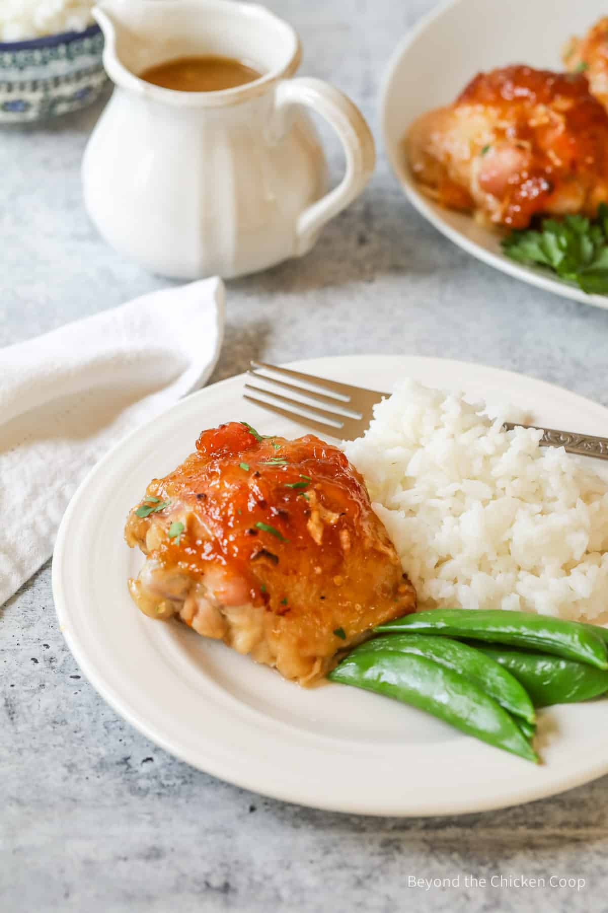 A plate with rice,  peas and chicken.