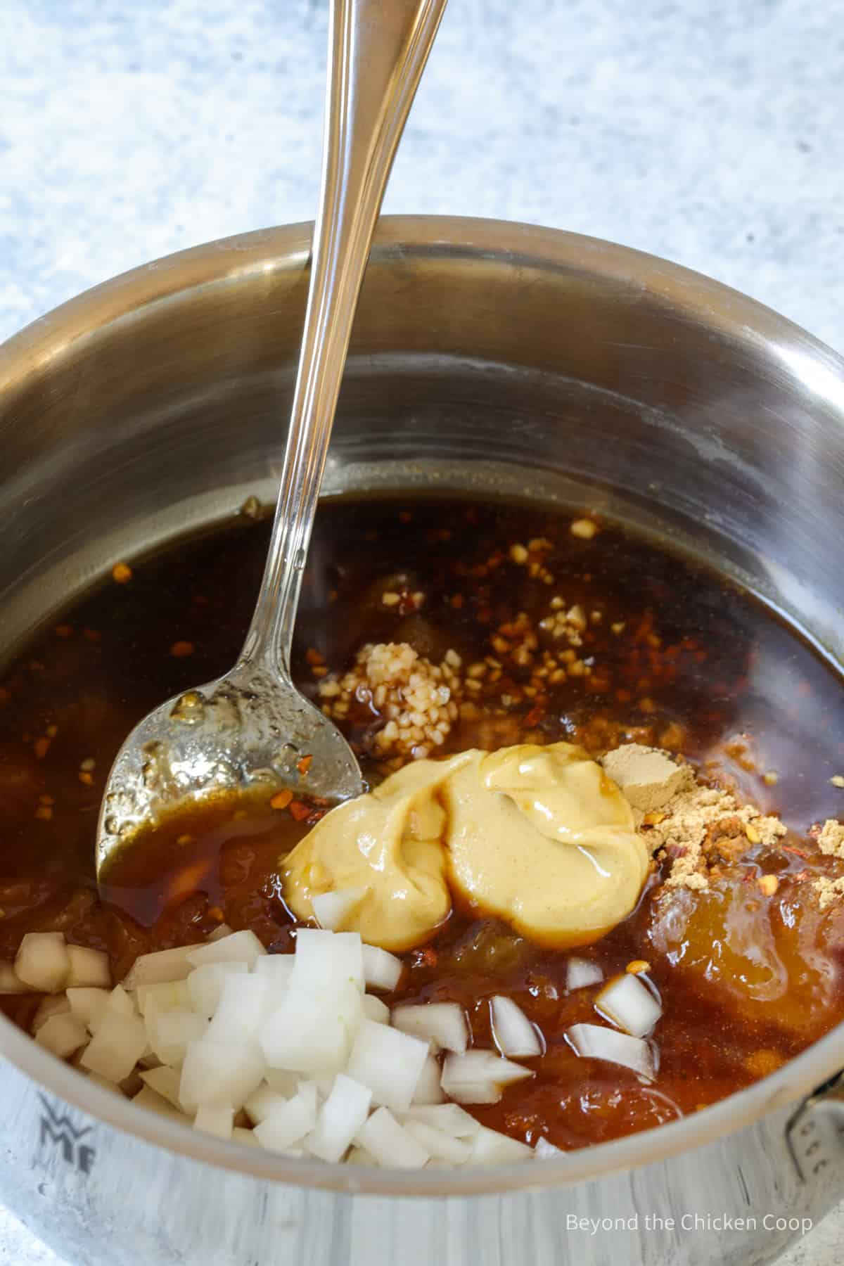 A saucepan with onions and spices.