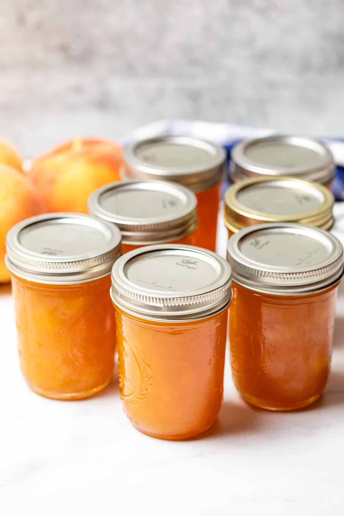 Small jars filled with peach jam.