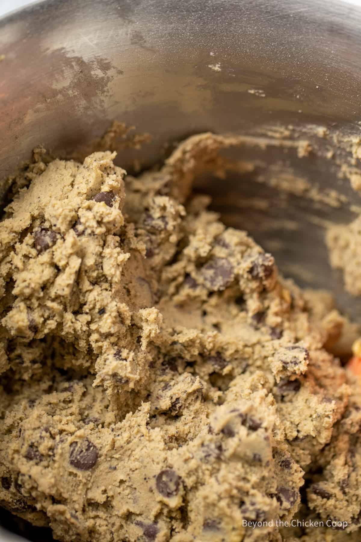 Chocolate chip cookie dough in a mixing bowl.