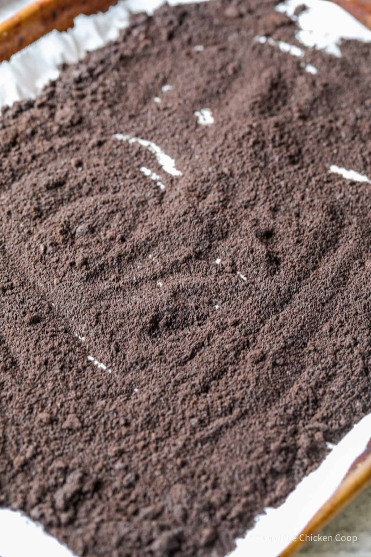 Dry coffee grounds on a baking sheet.