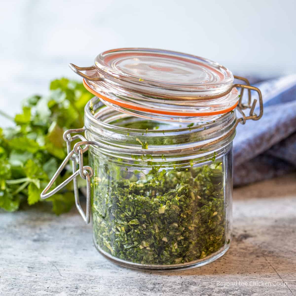 Freshly chopped parsley in a small glass jar.