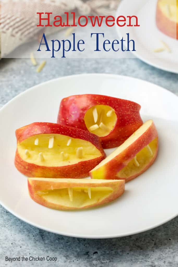 Sliced apples shaped as mouths with almond teeth.